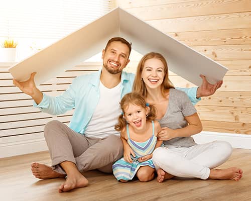 Happy family sitting together on floor in their new house in Colorado